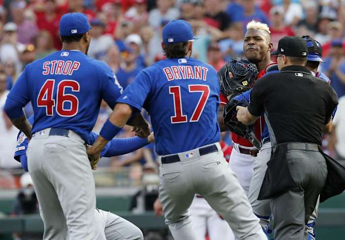 Cincinnati Reds right fielder Yasiel Puig (66) charges the mound after being hit by Chicago Cubs relief pitcher Pedro Strop (46) in the eighth inning at Great American Ball Park on Saturday, June 29, 2019. Chicago Cubs At Cincinnati Reds